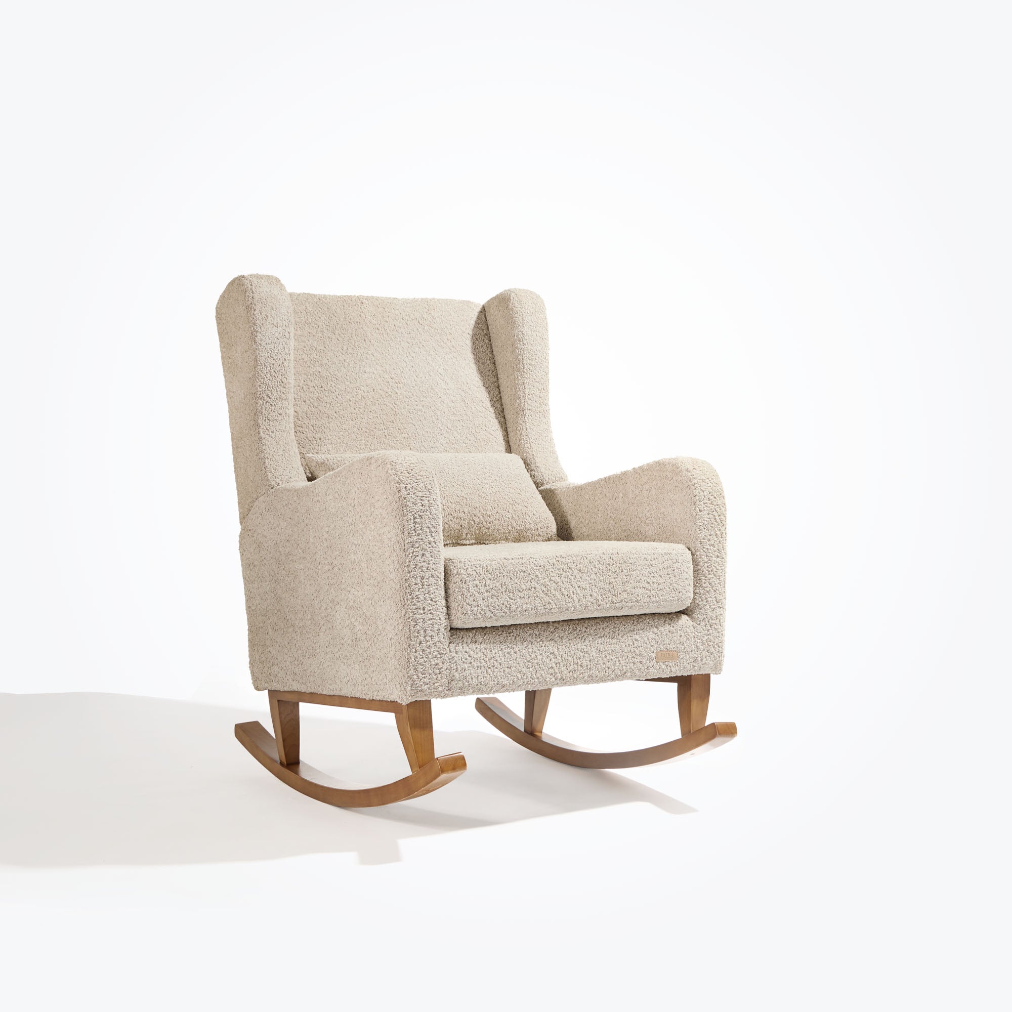 Angled cutout of the Harper Wingback rocking chair in teddy mushroom finish, showing plush wingback design and oak rocking base.