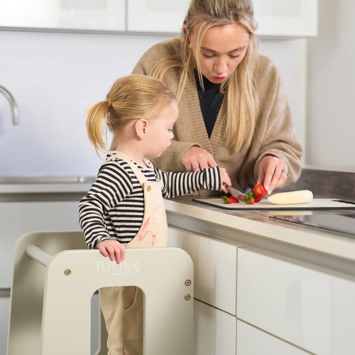 Mother and toddler prepare food using the Helping Hands Montessori learning tower in mushroom, supporting safe kitchen independence