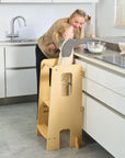 Mother and toddler prepare food together using the Helping Hands Montessori learning tower in natural wood, supporting safe interactive kitchen play