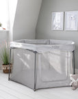 Lifestyle view of the grey Hexa playpen in a bright nursery, showing mesh sides and zip door for safe, visible supervised play