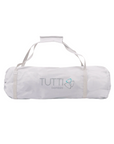 Compact Hexa playpen travel bag in light grey with handles, shown folded and ready for transport for easy on-the-go use
