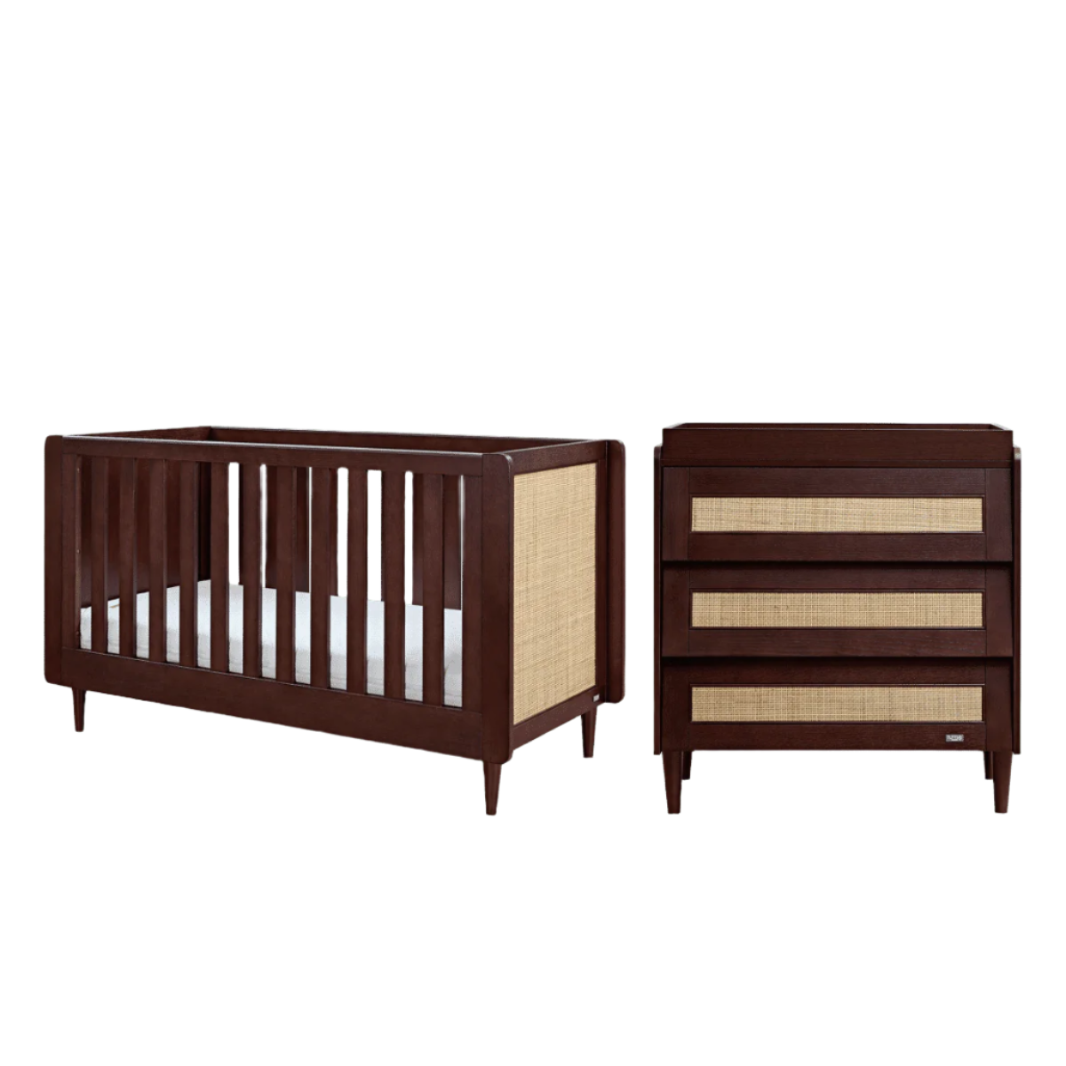 Japandi 2-piece nursery furniture set in warm walnut, featuring a cot bed and chest changer with woven rattan panels and solid wood frames in a cutout presentation.