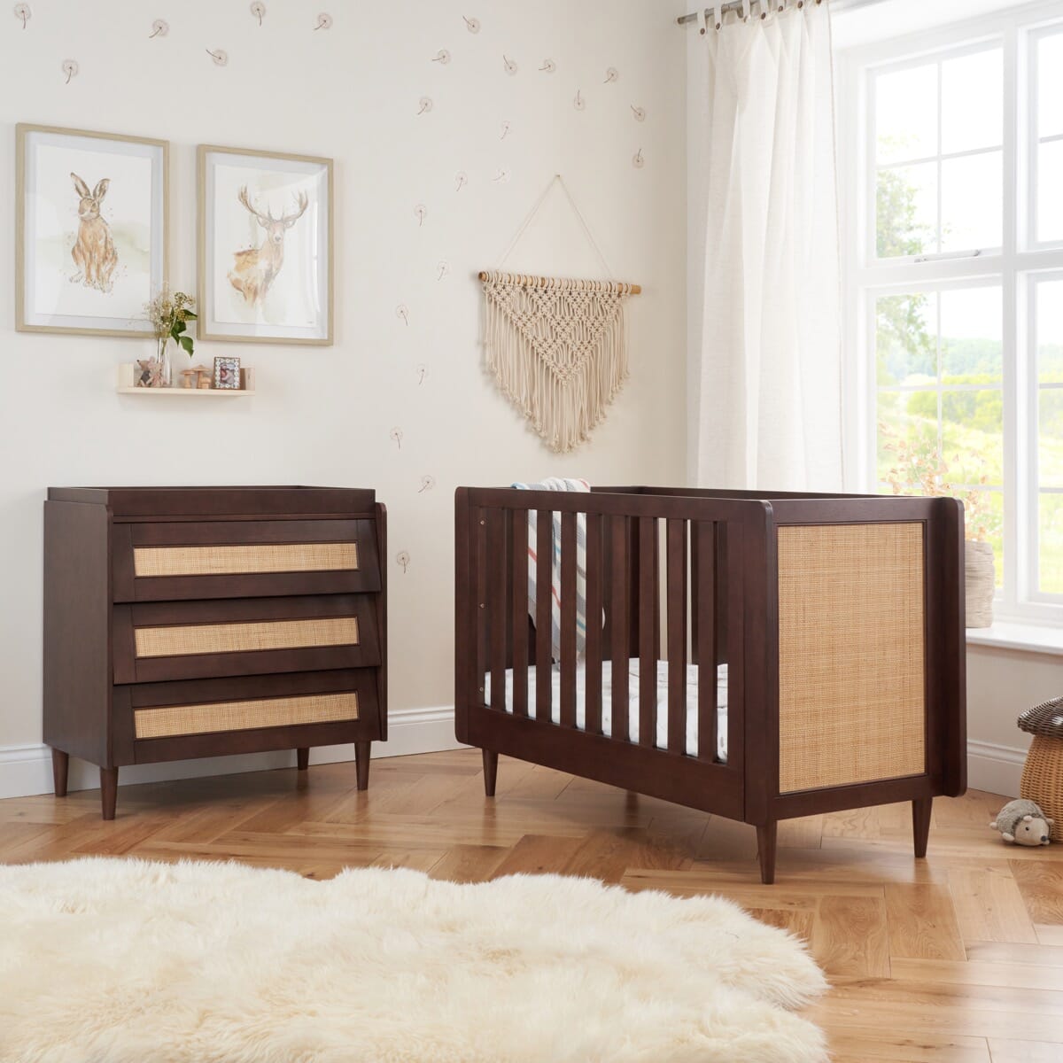 Japandi mini room set in warm walnut shown in a styled nursery, featuring the cot bed and chest changer with natural textures and calming wood tones.