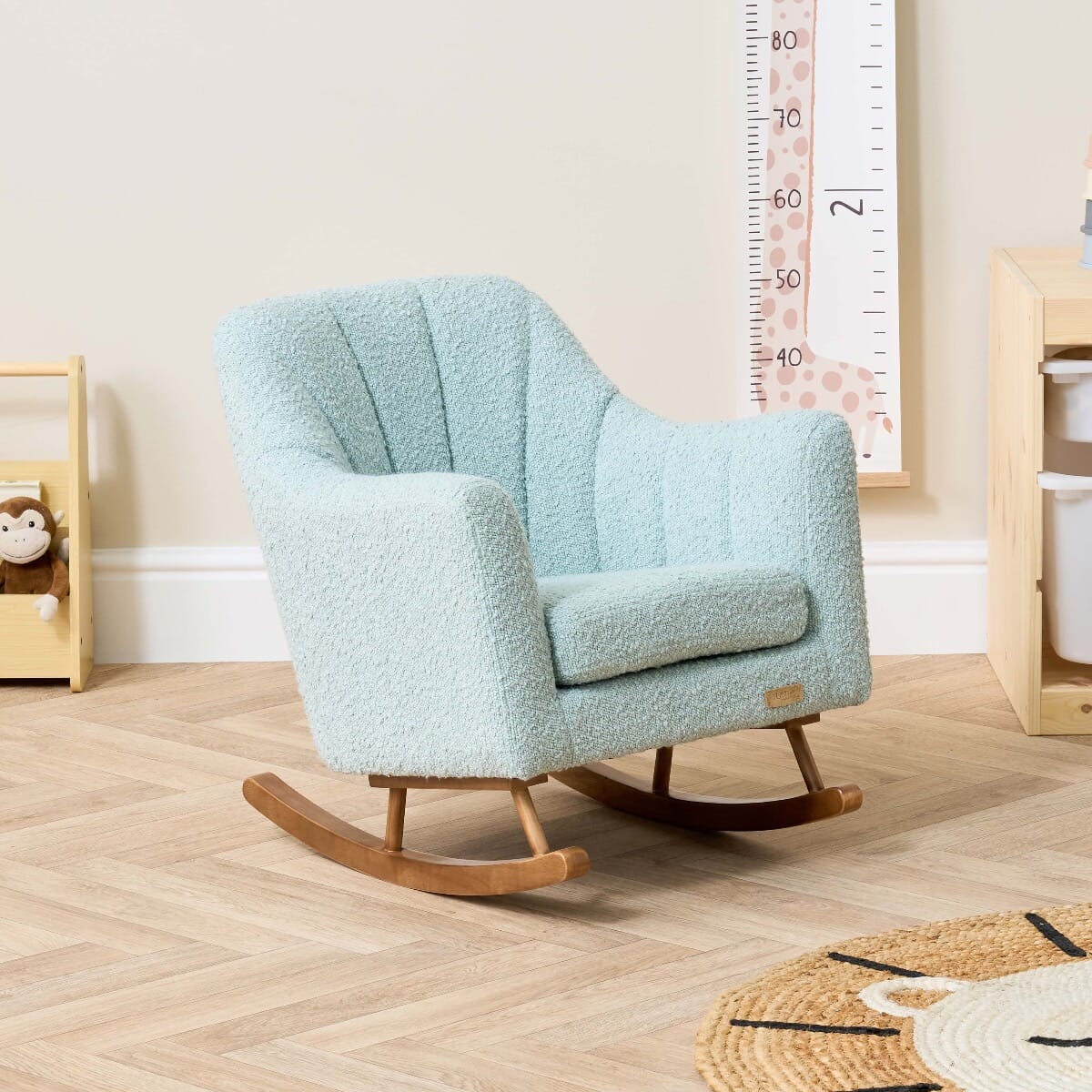 Angled view of the Jonah Mini Me children’s rocking chair in Ocean Stone, highlighting soft curves and wood rocking base