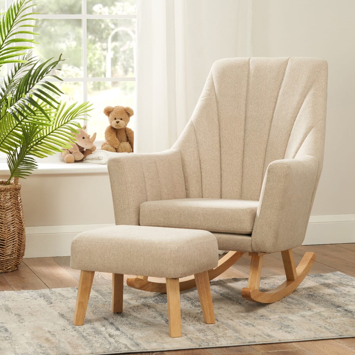 Lifestyle view of the Jonah rocking chair and footstool in Stone set in a cosy nursery corner, styled with plush toys and a soft rug for a warm and inviting space.