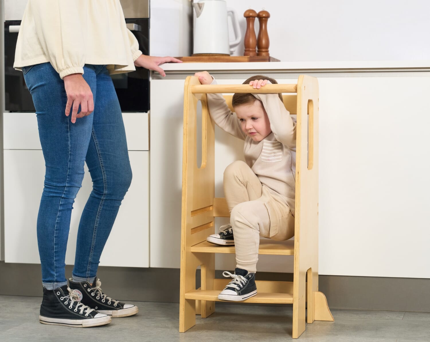Helping Hands Montessori Toddler Learning Tower in Natural Wood - image showing a boy climbing off the learning tower