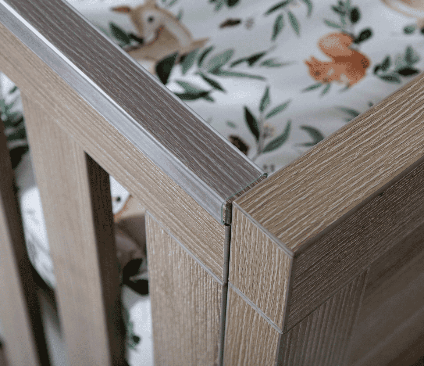 The Modena cot bed features teething rails