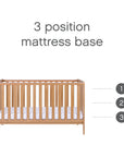 Front view of the Malmo cot bed in oak showing adjustable 3-position mattress base to support safer sleep as baby grows