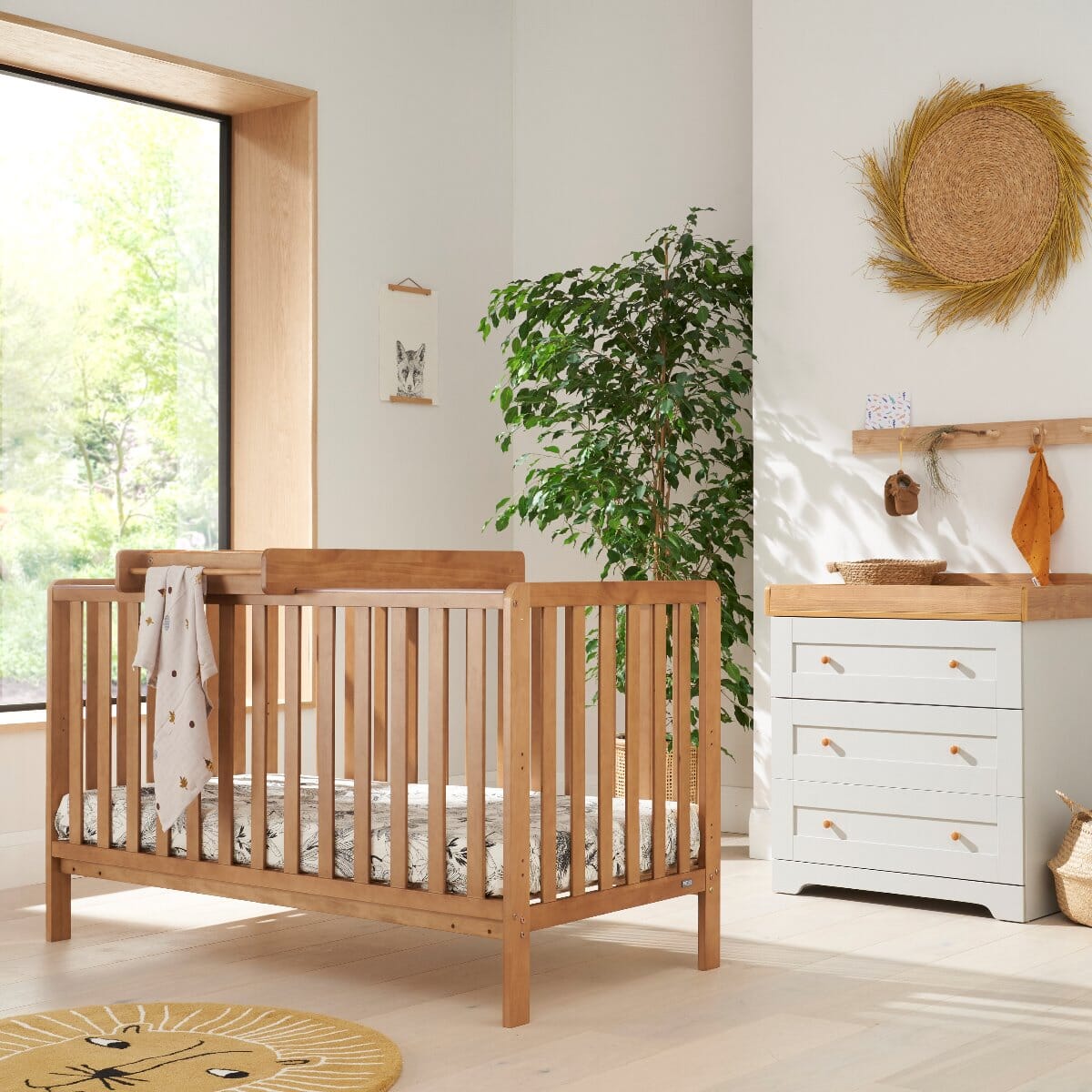 Malmo cot bed with changing top and Rio chest changer styled together in oak and dove grey, creating a cohesive nursery set