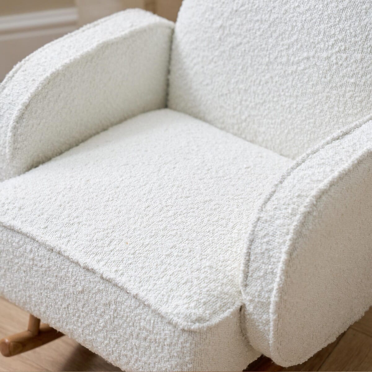 Close-up view of the Micah Mini Me Rocking Chair in Fresh Cream highlighting soft boucle-style fabric and padded seating for extra comfort.