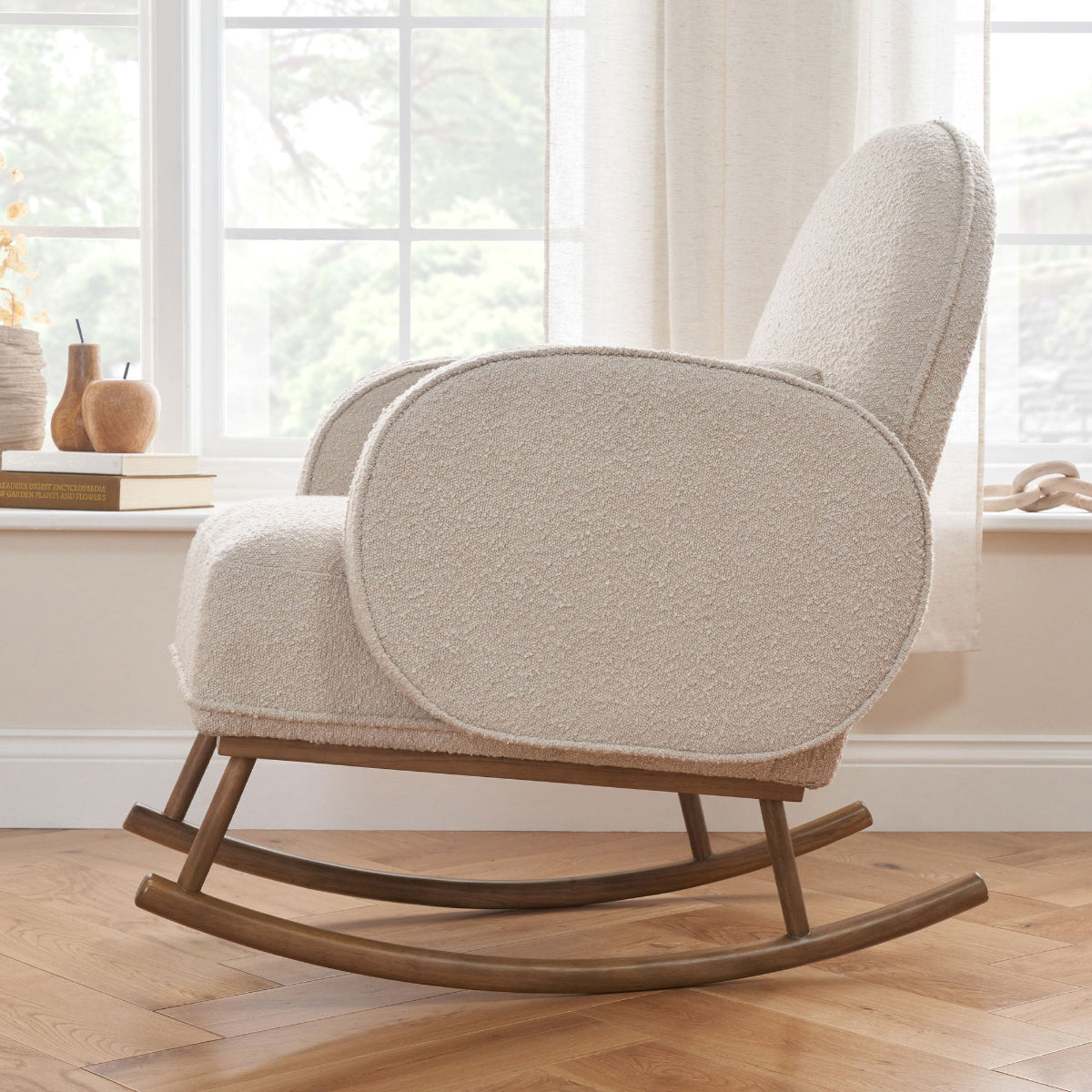 Side view of the Micah rocking chair in biscuit boucle in a lifestyle setting, highlighting its soft texture and wooden curved rocking legs.