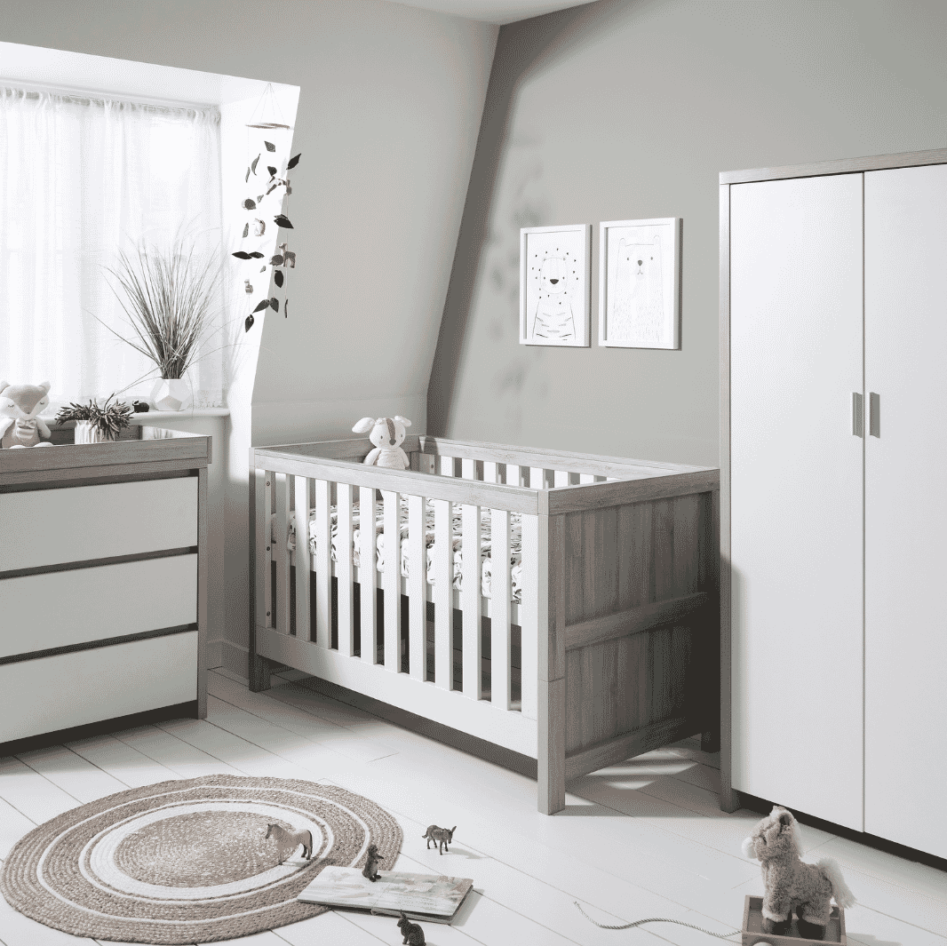 Modena 3-piece nursery furniture set in grey ash and white, featuring cot bed, changing unit, and wardrobe, styled in a modern nursery room with natural light and playful decor