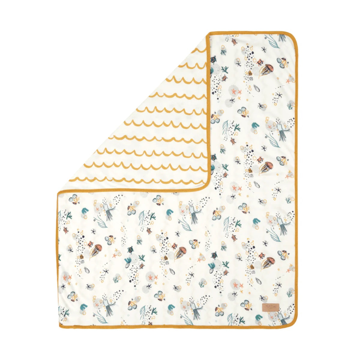 Folded corner view of Our Planet coverlet, reversible organic cotton with playful sea-inspired prints and mustard trim for cosy comfort