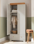 Room setting view of Rio Wardrobe in Dove Grey and Honey Oak, featuring hanging rail, storage shelf, and soft-close doors