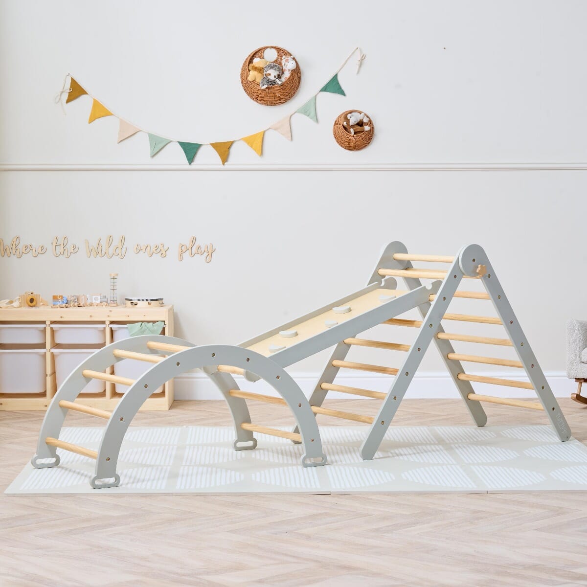 Styled room view of the Scala Montessori Pikler climbing frame in mushroom finish with ramp and arch set for imaginative play