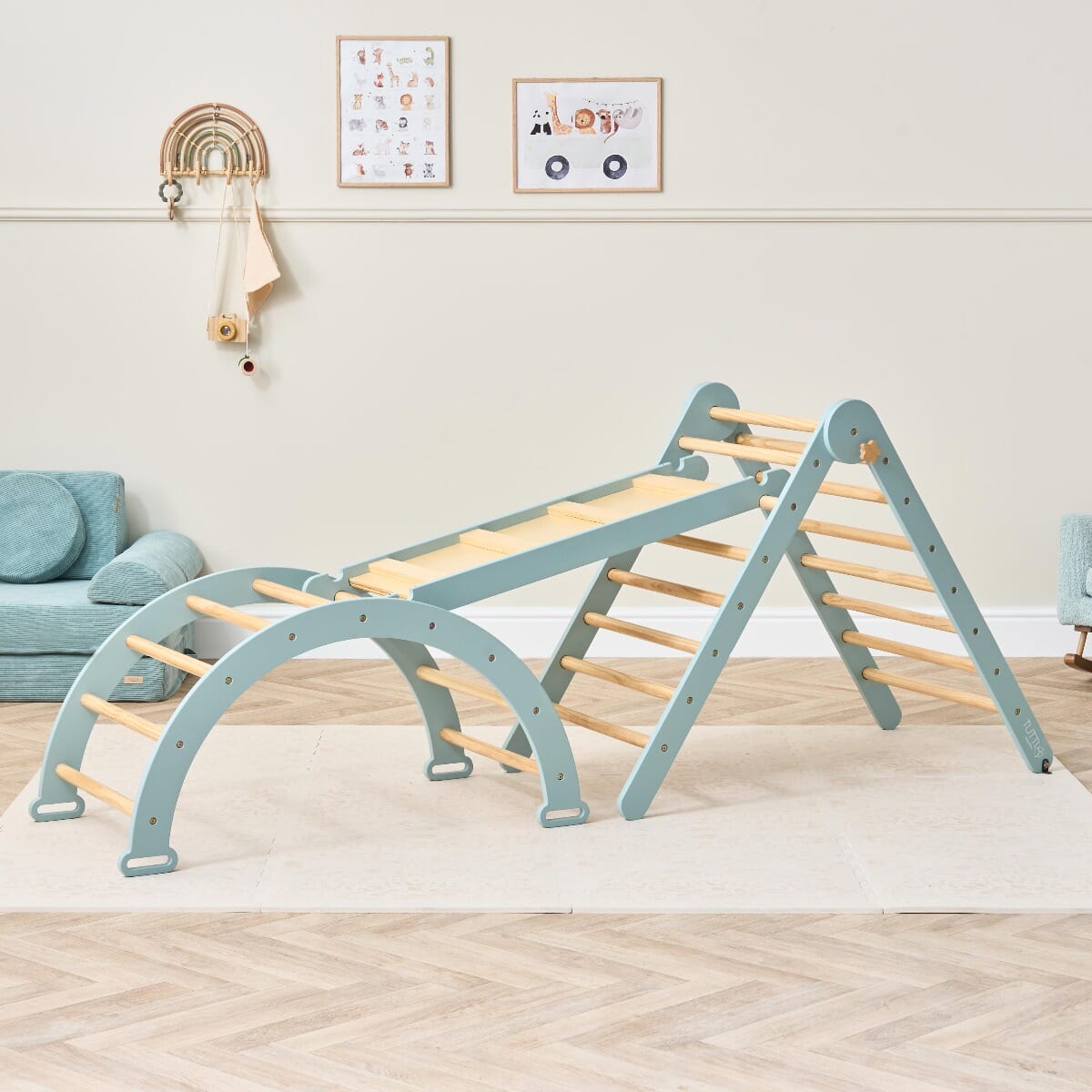 Styled room view of the Scala Montessori climbing frame in ocean stone with wall, arch, and triangle, designed to inspire Montessori play and movement.