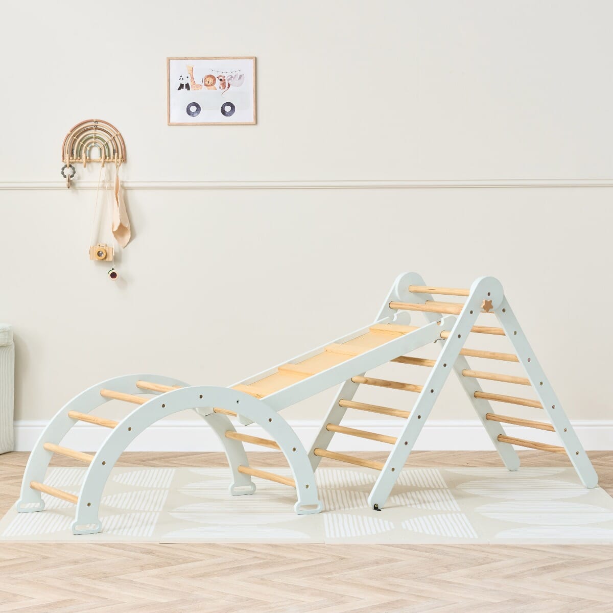 Styled room view of the Scala Montessori Pikler climbing frame in sea mist, blending natural wood tones with calm pastel play design