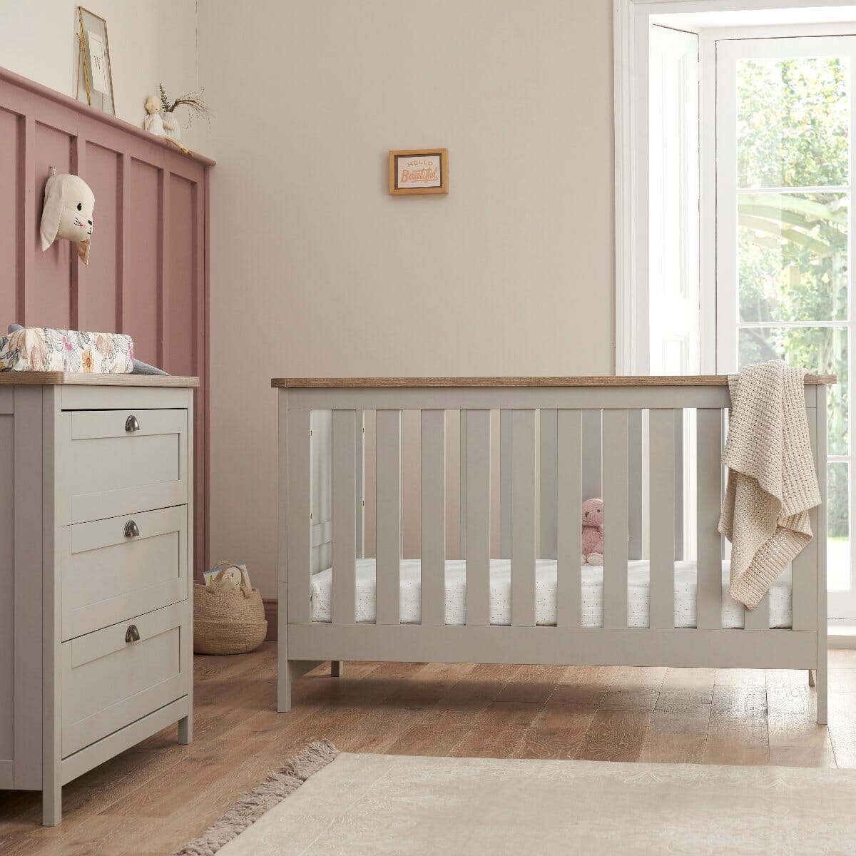 Verona 2 Piece Room Set in Dove Grey and Oak nursery setup with cot bed in infant stage and chest changer, offering a cohesive space-saving solution for sleep and nappy changing.