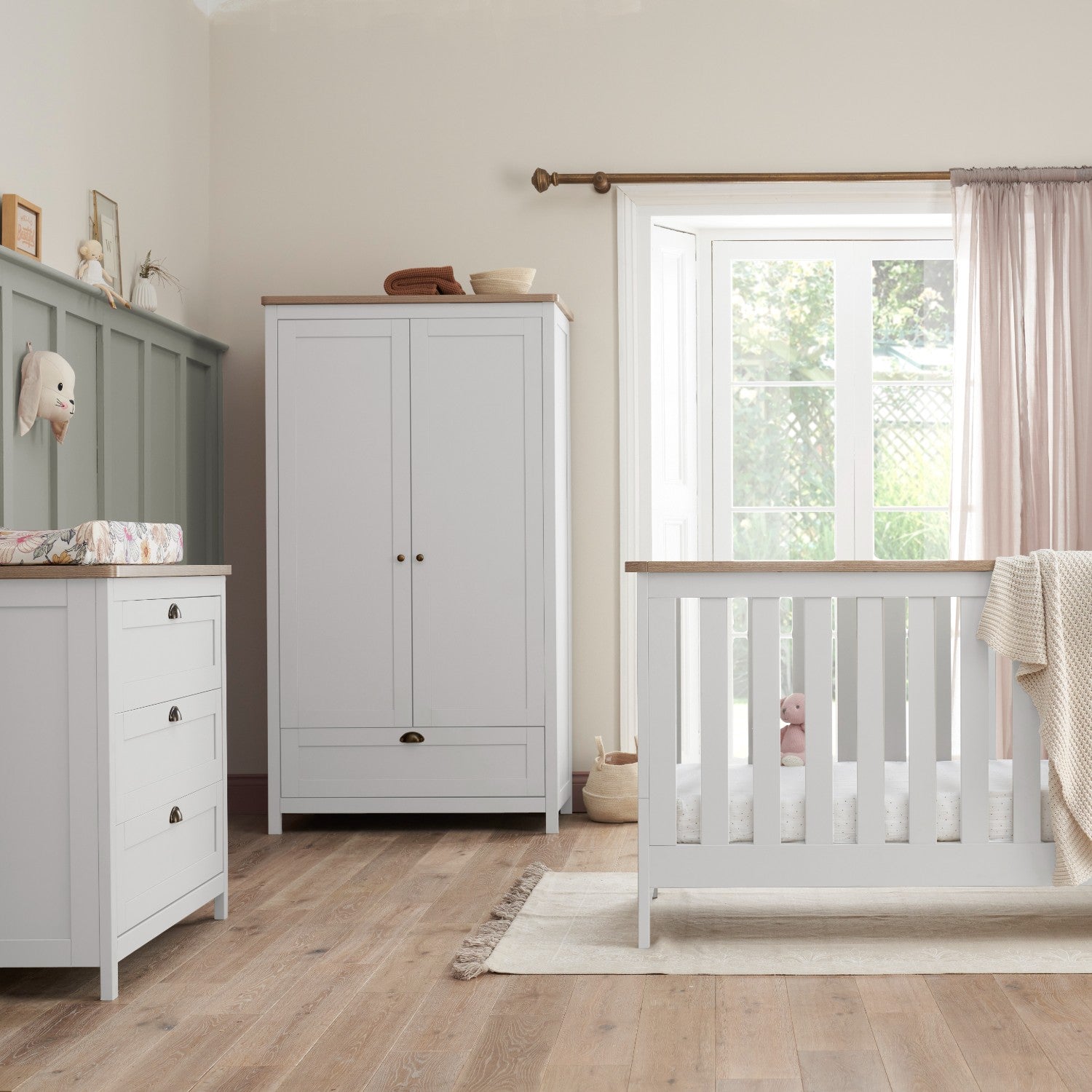 verona 3 piece nursery furniture set in white and oak styled in a modern room setting, showing versatile, coordinated design