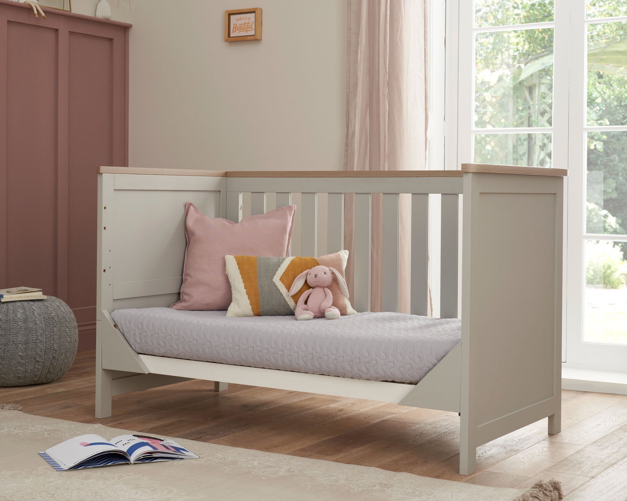 Verona Cot Bed in Dove Grey and Oak transformed into sofa bed mode, providing a cosy day seating option for older toddlers or young children.