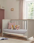 Verona cot bed in dove grey and oak shown in sofa mode, providing a practical seating solution as your child grows.