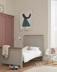 Verona Cot Bed in Dove Grey and Oak converted into toddler bed mode, designed to support independent sleeping with low height and sturdy wooden frame.