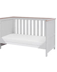 verona cot bed in dove grey and oak - shown converted to stylish sofa bed mode with open side for seated use, ideal for transitioning from cot to toddler space