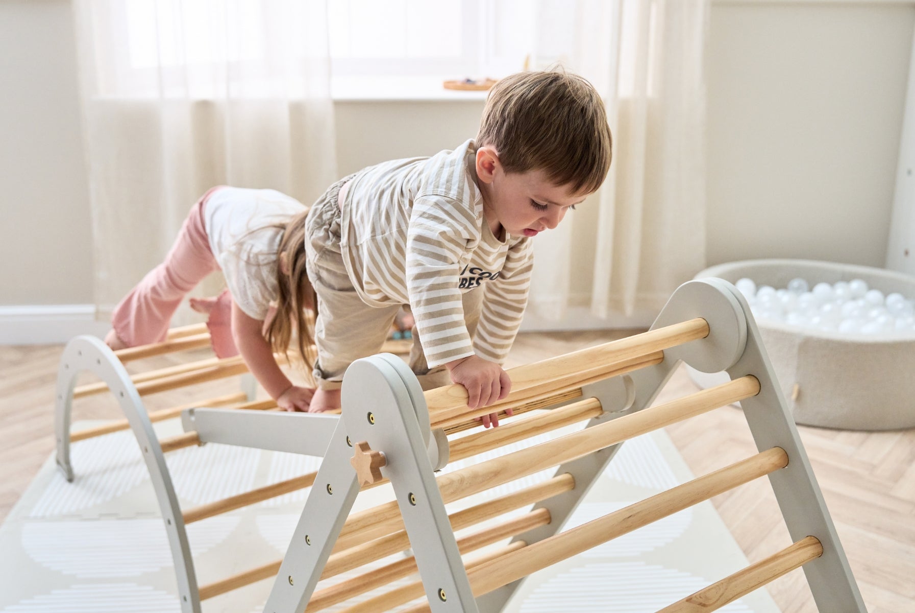 children carefully climbing the playrama climbing frame