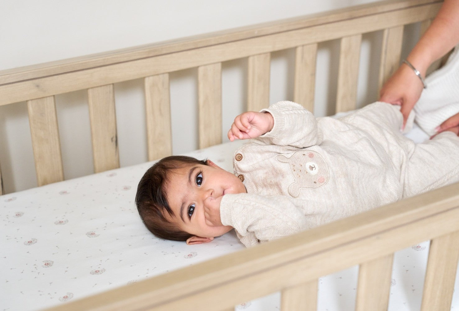 toddler relaxing in casa mini cot bed 
