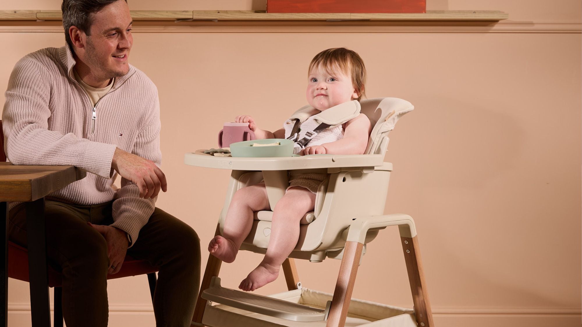 Baby eating in their Nova Highchair in Scandinavian Walnut & Ecru