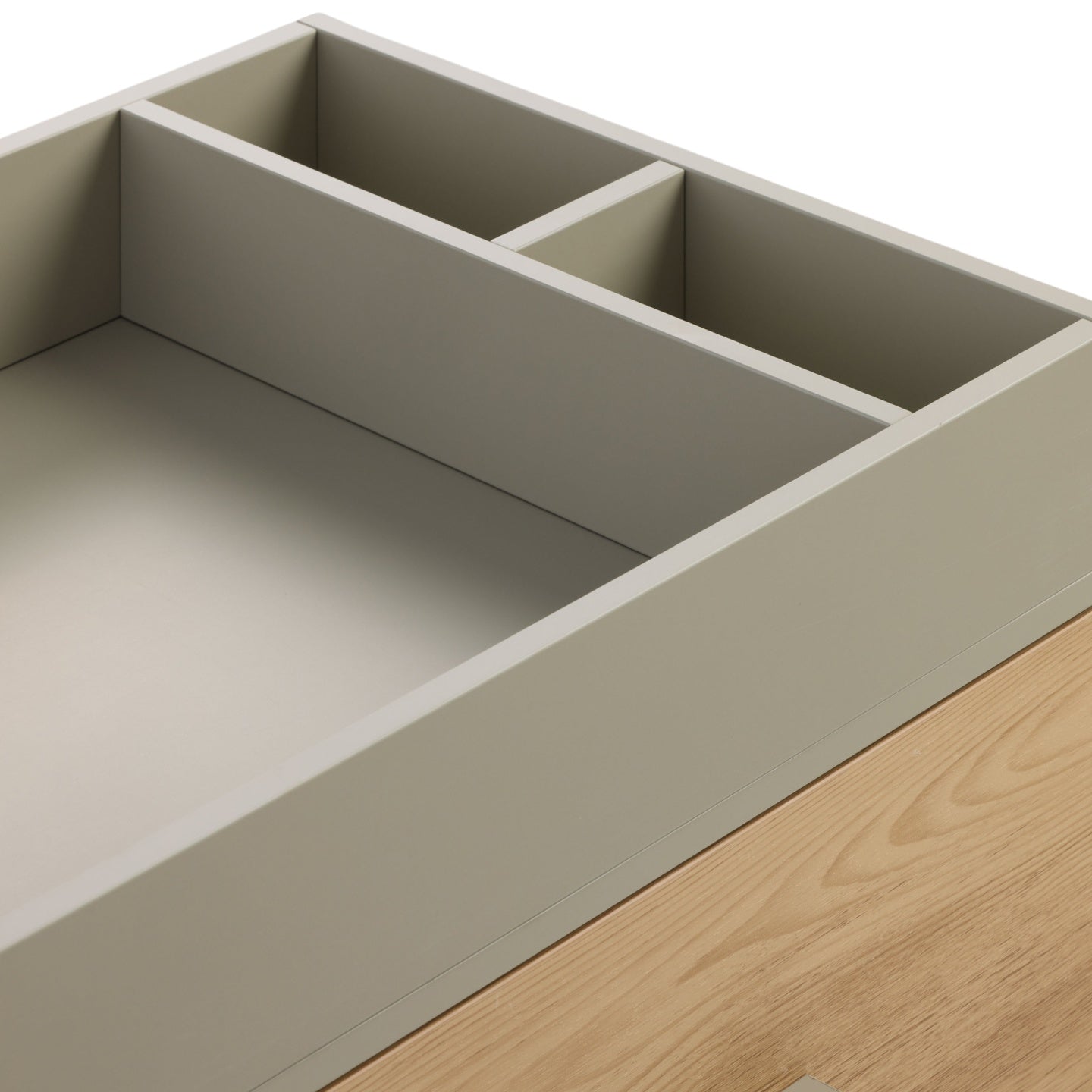 Close-up of Hallee chest changer in sage and golden oak showing removable changing top with integrated storage dividers.