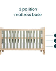 Diagram of the Kuba cot bed in pickled oak and sage weave, highlighting the three adjustable mattress base heights as baby grows