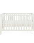 A cashmere Alba cot bed with vertical slats and a mattress inside, shown against a plain white background.