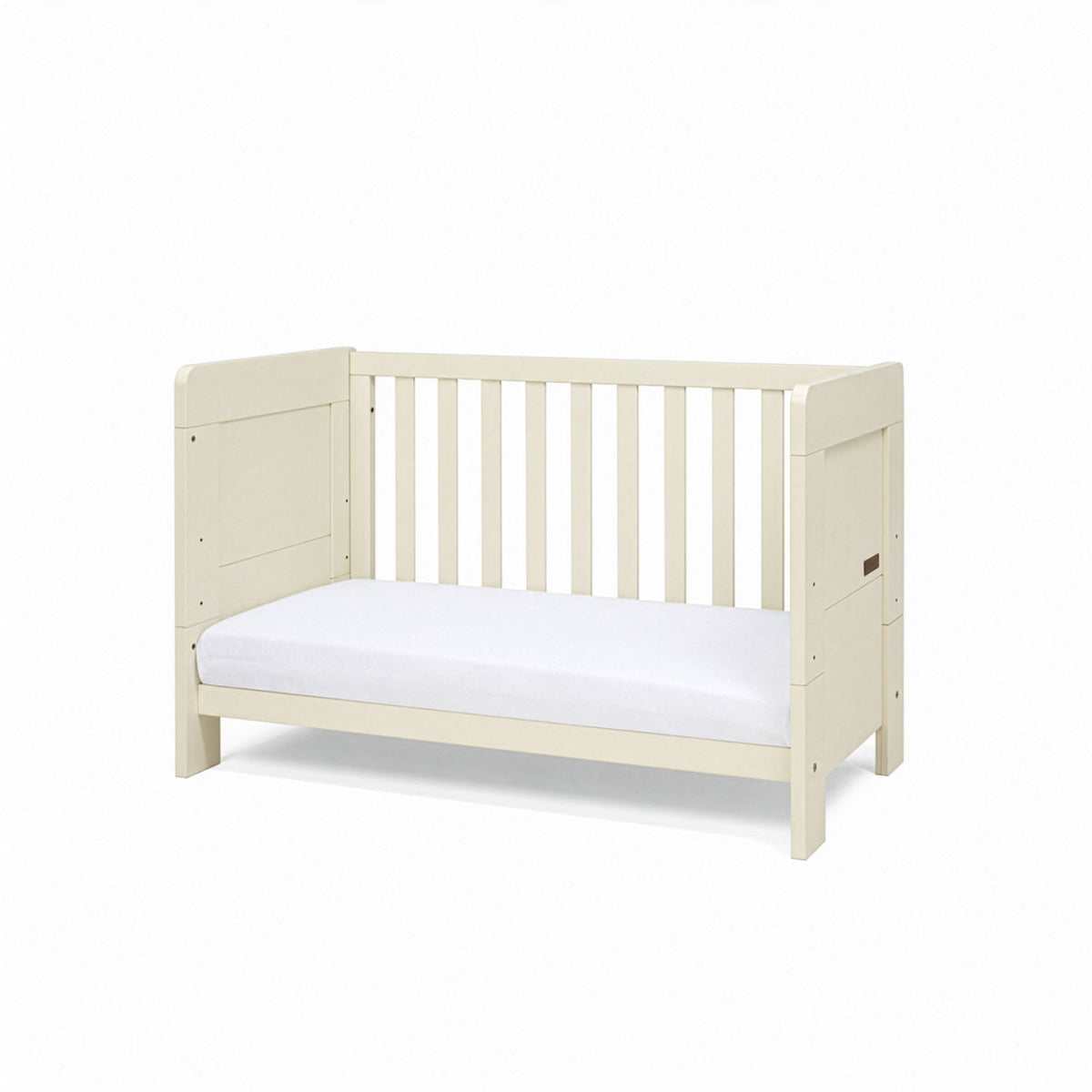 A side view of the mini Alba cot bed in cashmere converted into a toddler's sofa in a white background.