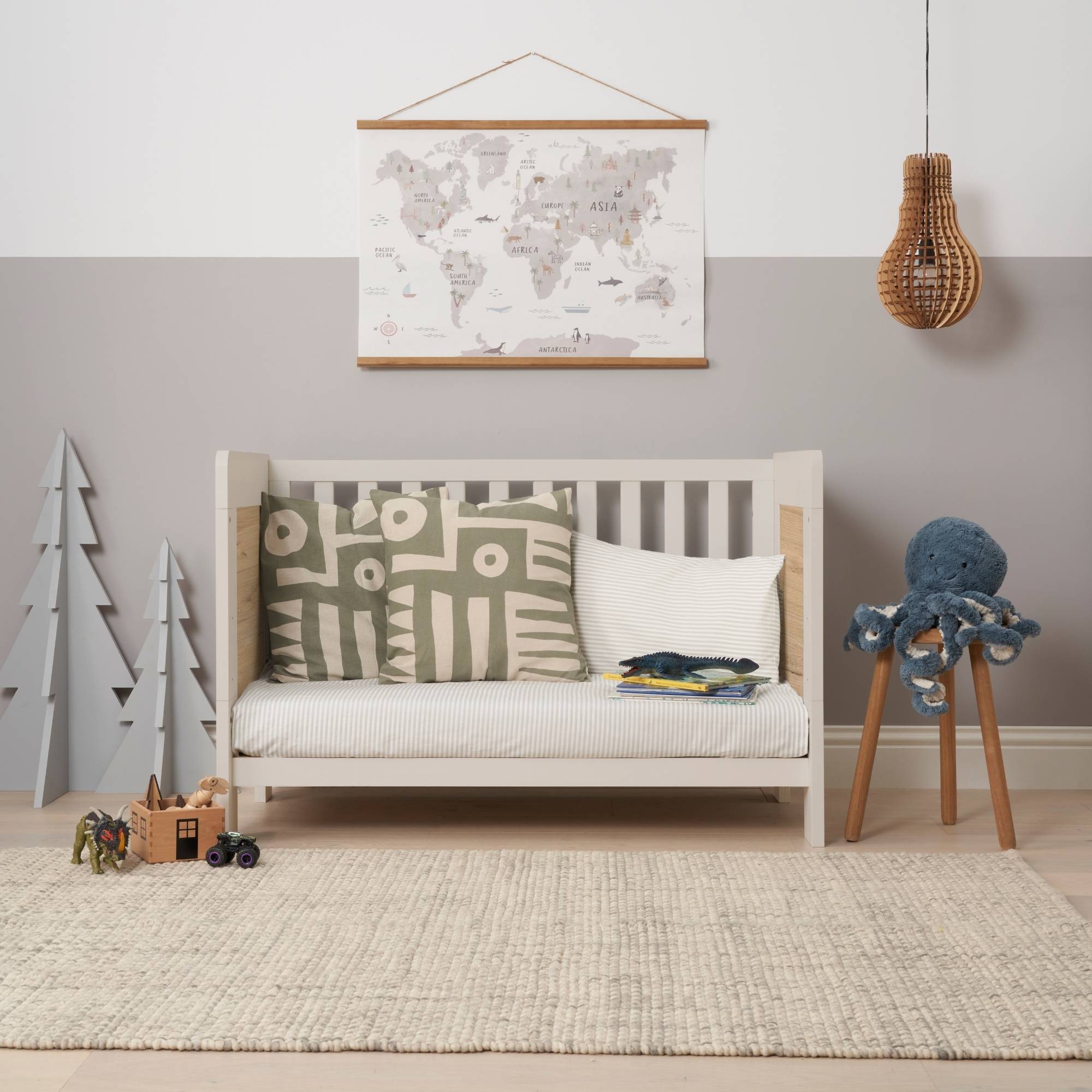 Alba Mini cot bed transformed into a sofa mode in a modern nursery