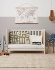 Alba Mini cot bed transformed into a sofa mode in a modern nursery