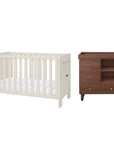 A nursery furniture set featuring a white convertible cot bed and a dark brown wooden changing table with three drawers, shown against a plain white background.