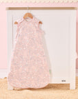 Tiny Tails baby sleep bag hanging in soft pink nursery, featuring calming woodland print for a serene and stylish bedtime look