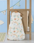 Good Life baby sleep bag hanging in a light nursery with blue wall and bunting, featuring calming farmyard print