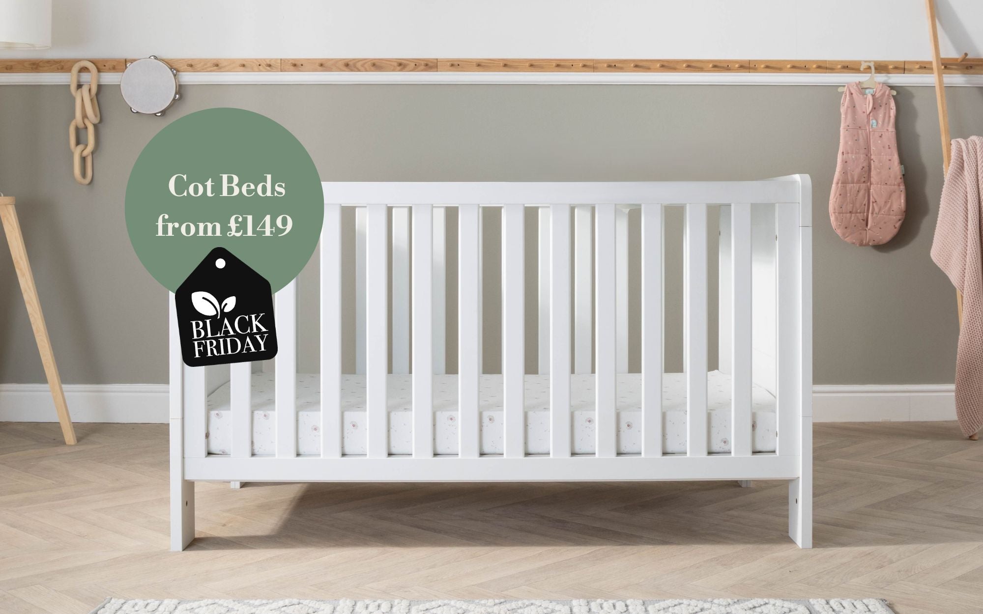 White crib in a room with a 'Black Friday' sale tag on a green circle