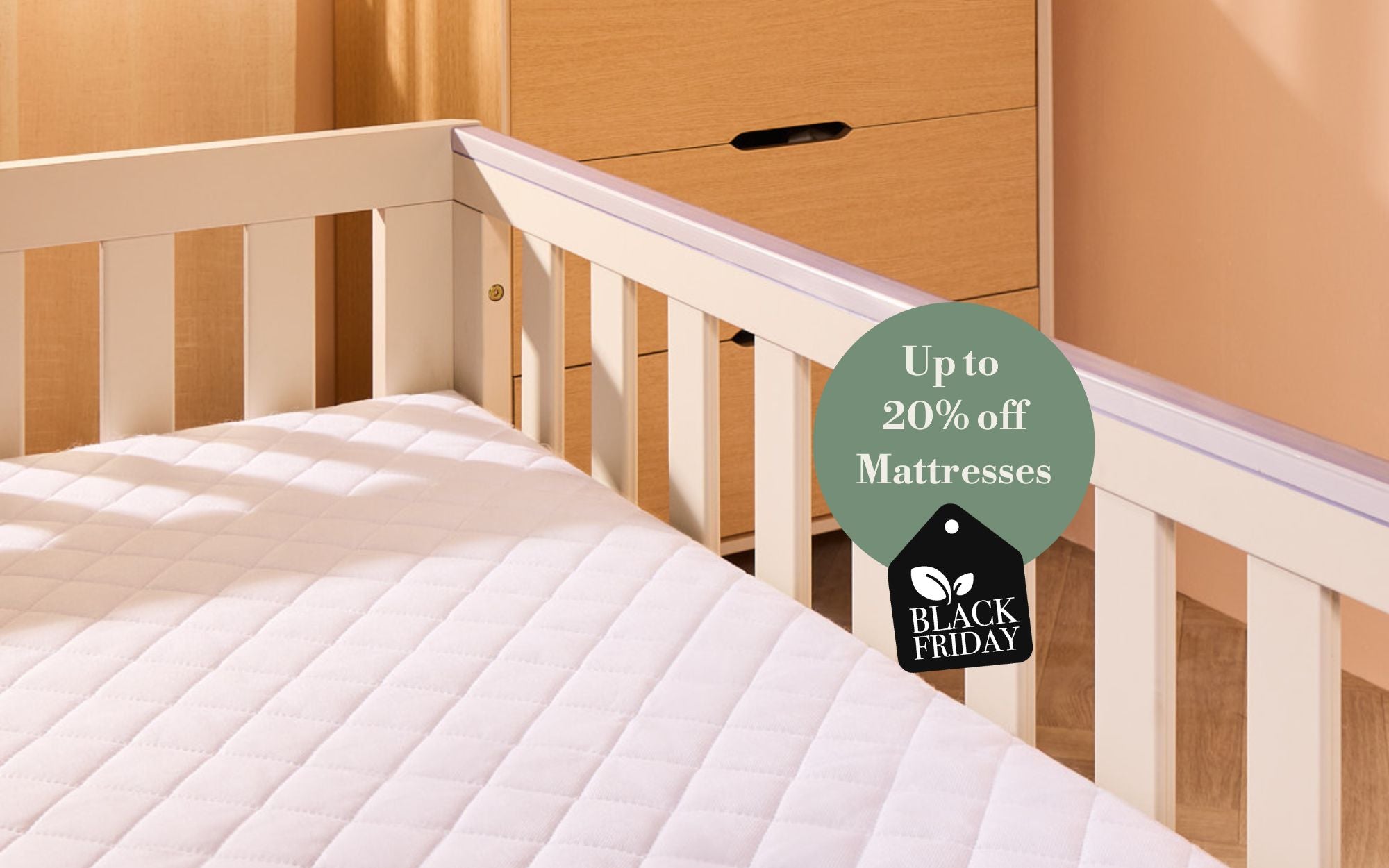 Crib with mattress and 'Black Friday' mattress sale tag