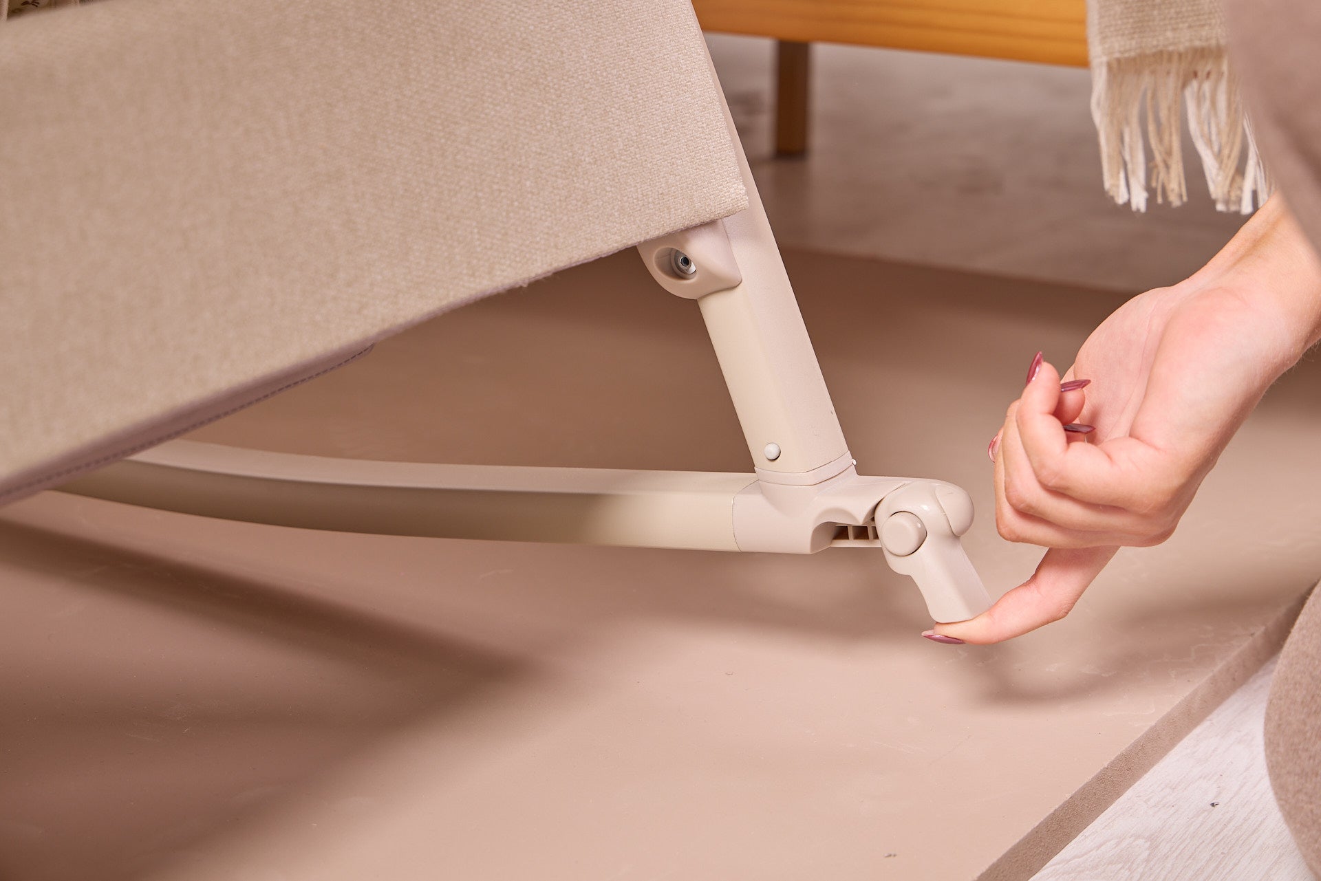 lifestyle of the CoZee Air 2 showing the locking foot brake engaged to secure the crib.