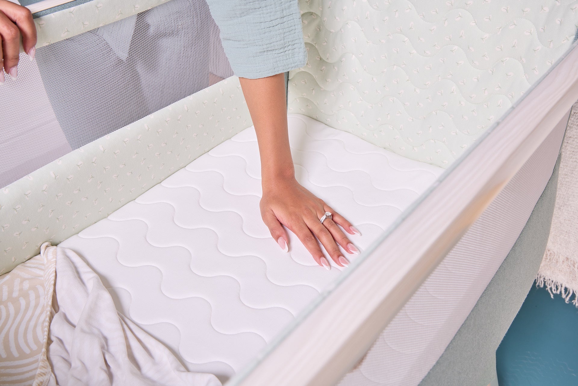 lifestyle of the CoZee Air 2 kelp showing the breathable, supportive mattress surface designed for comfortable newborn sleep.
