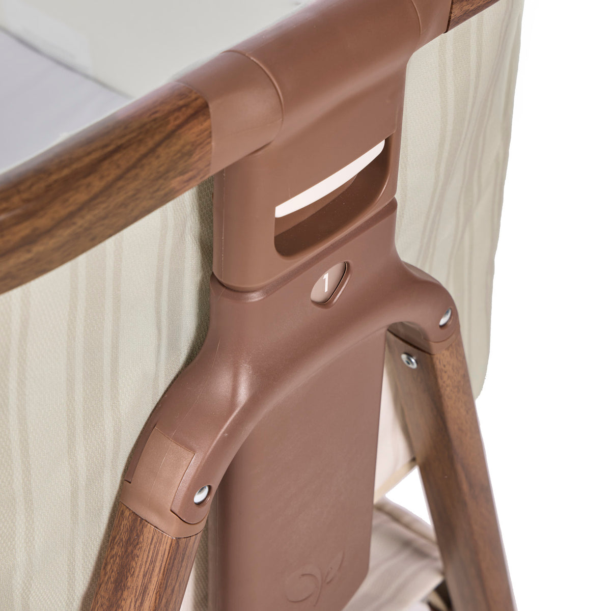 Angle view of the CoZee Air 2 bedside crib in rich walnut and cashmere vintage stripe showing numbered height adjustment settings for bedside alignment.