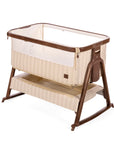 A baby bedside crib with a cashmere vintage stripe and a dark rich walnut frame, shown on a clean white background.