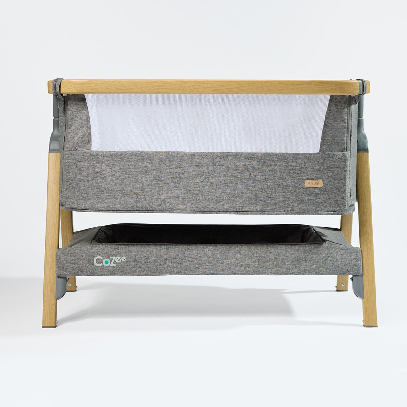 CoZee Bedside Crib in Oak and Charcoal with breathable mesh sides, drop-side panel, and lockable castors – product cutout on white background