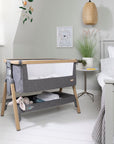 CoZee Bedside Crib in Oak and Charcoal with breathable mesh sides and drop-down panel