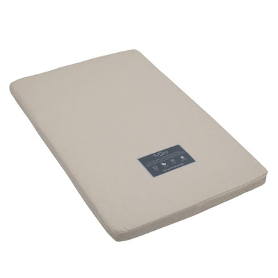 Angled cutout view of the CoZee mattress with natural cover, designed with coir and wool layers for breathable, eco-friendly support.