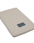 Angled cutout view of the CoZee mattress with natural cover, designed with coir and wool layers for breathable, eco-friendly support.