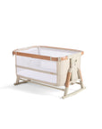 Cutout view of the CoZee Scandi in bassinet mode with raised sides, mesh panels and wooden legs for modern nursery style